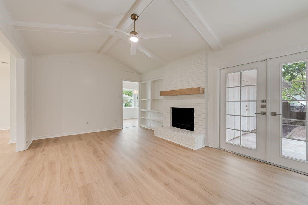 13427 Purple Sage Road Dallas, TX 75240 - Photo 5 of 31 Vaulted ceilings with exposed beams add character and dimension to the family room.