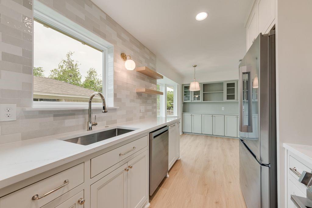 13427 Purple Sage Road Dallas, TX 75240 - Photo 8 of 31 The kitchen balances clean design with everyday function, featuring updated finishes and a full suite of LG stainless steel appliances.