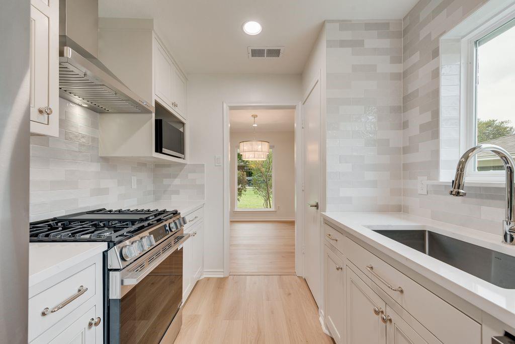 13427 Purple Sage Road Dallas, TX 75240 - Photo 10 of 31 LG stainless steel appliances—including a gas range, convection oven with air fry, built-in microwave, and refrigerator—are thoughtfully integrated for both everyday cooking and entertaining.