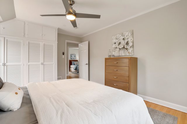309 East Avenue Park Ridge, IL 60068 - Photo 18 of 32 a bedroom with a bed and a chandelier