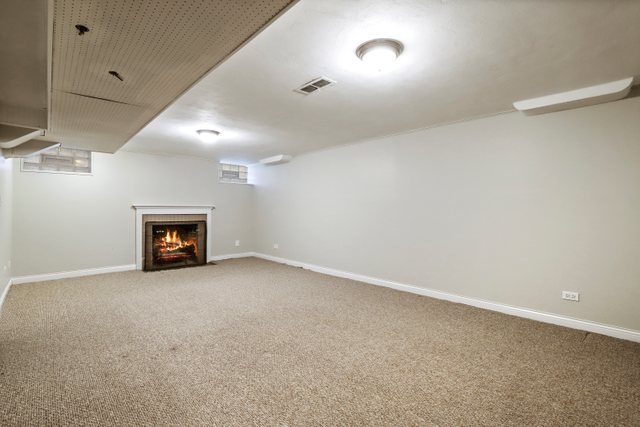 309 East Avenue Park Ridge, IL 60068 - Photo 23 of 32 an empty room with a fireplace and fan