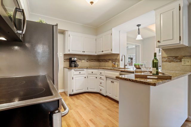 309 East Avenue Park Ridge, IL 60068 - Photo 10 of 32 a kitchen with granite countertop a sink stove and cabinets