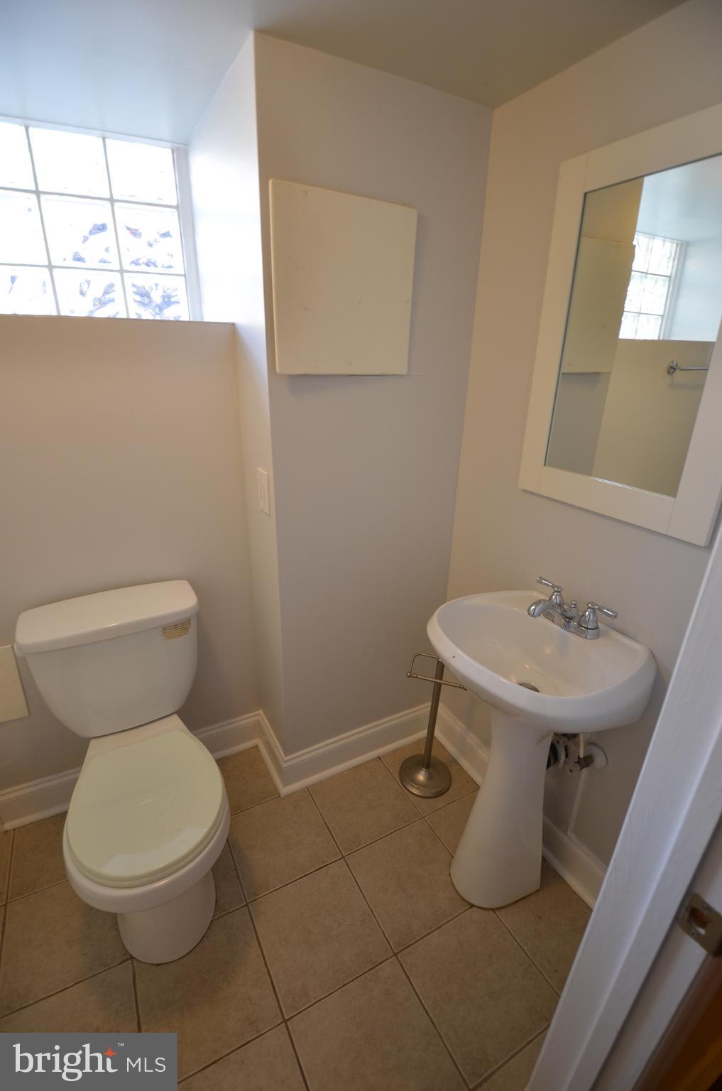 26 North E Avenue Baltimore, MD 21224 - Photo 12 of 22 a bathroom with a toilet sink and mirror