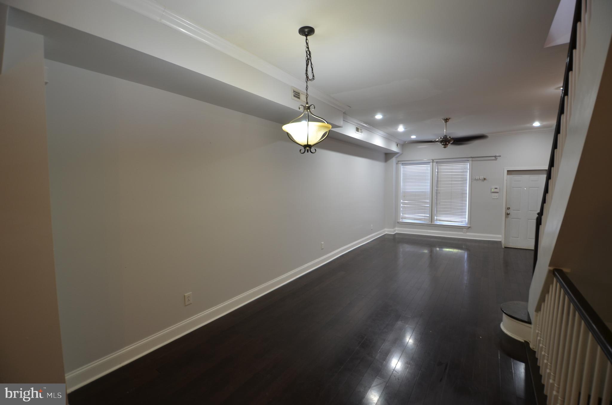 26 North E Avenue Baltimore, MD 21224 - Photo 2 of 22 a view of a room with window and wooden floor