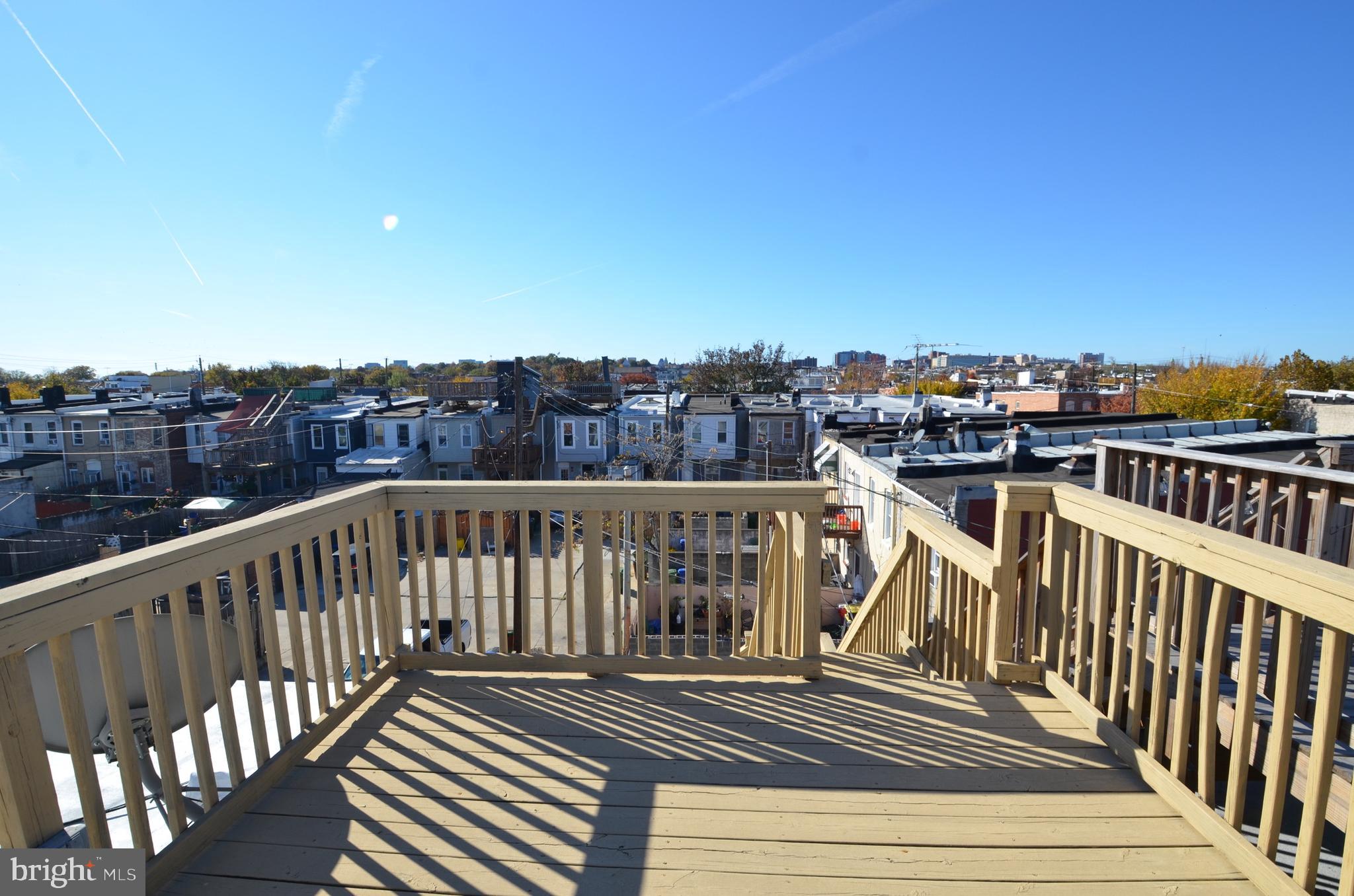 26 North E Avenue Baltimore, MD 21224 - Photo 21 of 22 a view of a balcony with wooden floor