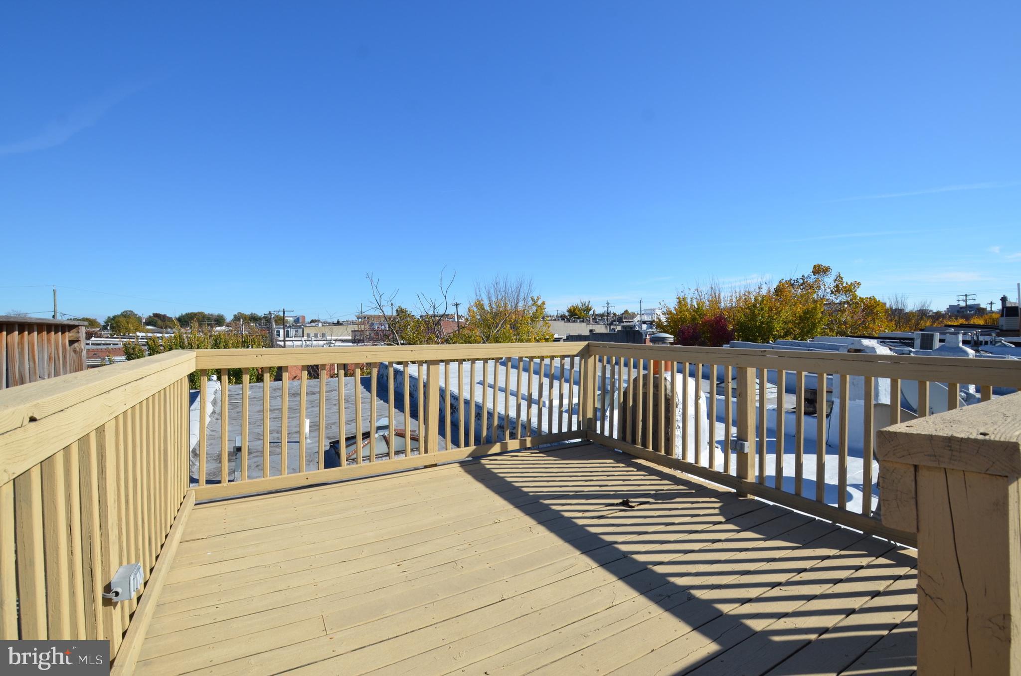 26 North E Avenue Baltimore, MD 21224 - Photo 22 of 22 a balcony with wooden floor and fence