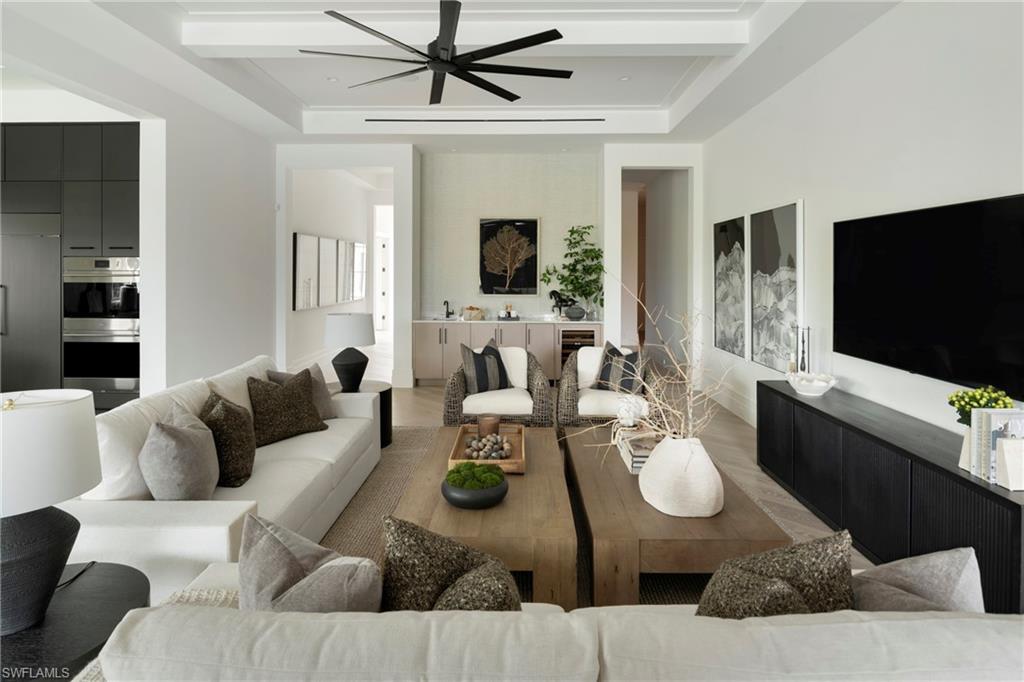 6704 Newport Road Naples, FL 34109 - Photo 6 of 47 a living room with furniture and a flat screen tv