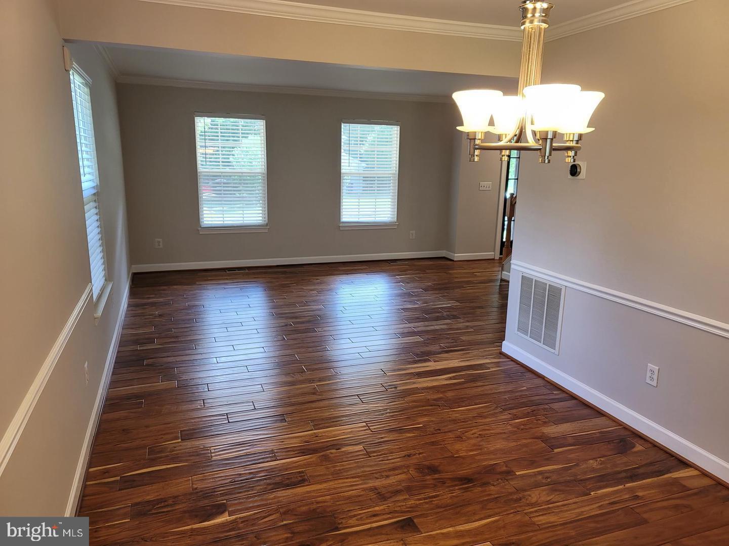 4788 Pearson Drive Woodbridge, VA 22193 - Photo 4 of 23 a view of a livingroom with wooden floor a chandelier