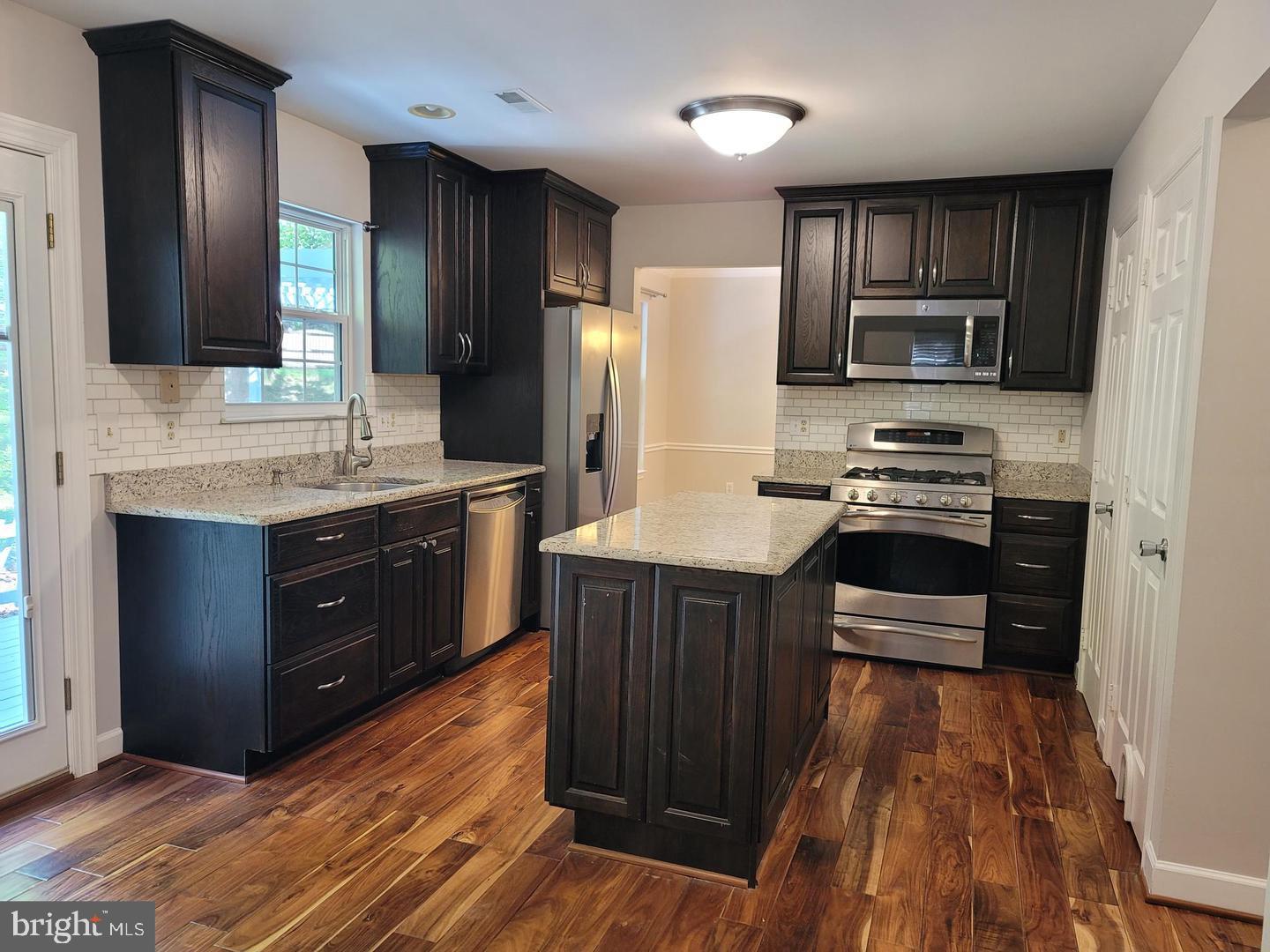 4788 Pearson Drive Woodbridge, VA 22193 - Photo 6 of 23 a kitchen with stainless steel appliances wooden cabinets and a stove top oven