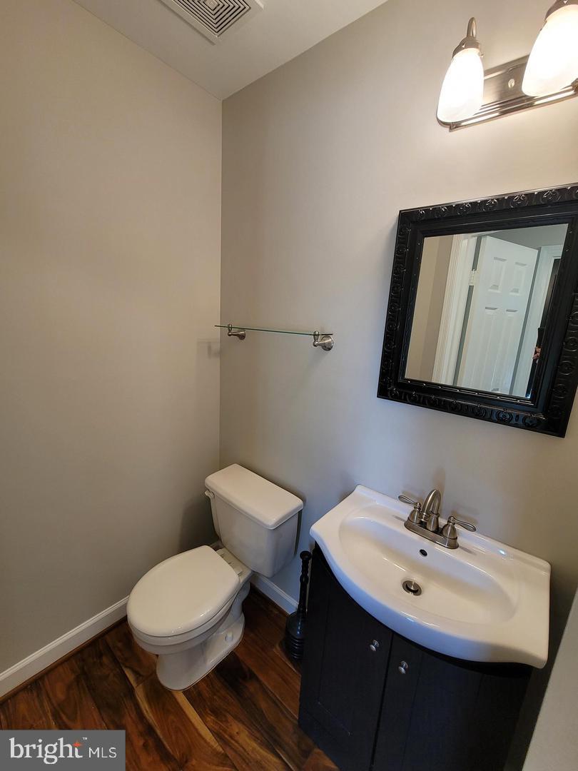 4788 Pearson Drive Woodbridge, VA 22193 - Photo 8 of 23 a bathroom with a toilet a sink and mirror