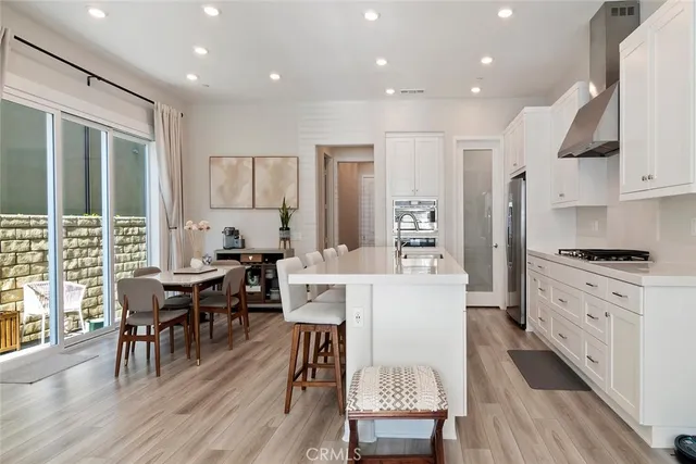 a large kitchen with cabinets table and chairs