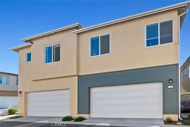 a view of a patio with a table and chairs under an umbrella