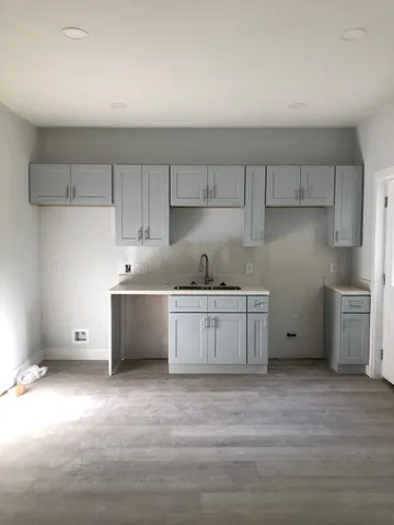 a kitchen with granite countertop a sink and a stove