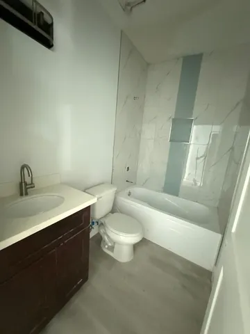 a bathroom with a toilet a sink and bathtub