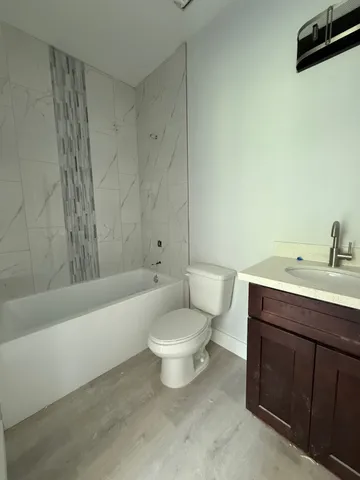 a bathroom with a sink toilet and bathtub