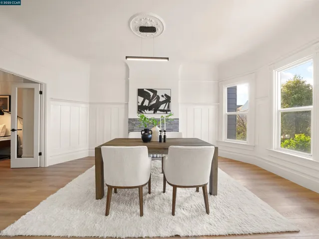 a view of a dining room with furniture window and wooden floor