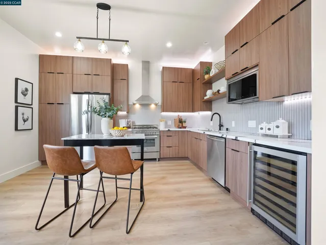 a kitchen with stainless steel appliances kitchen island granite countertop a sink and cabinets