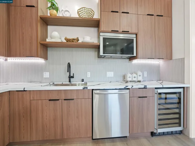 a kitchen with stainless steel appliances a sink and a microwave