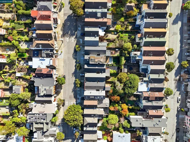 an aerial view of residential houses with outdoor space
