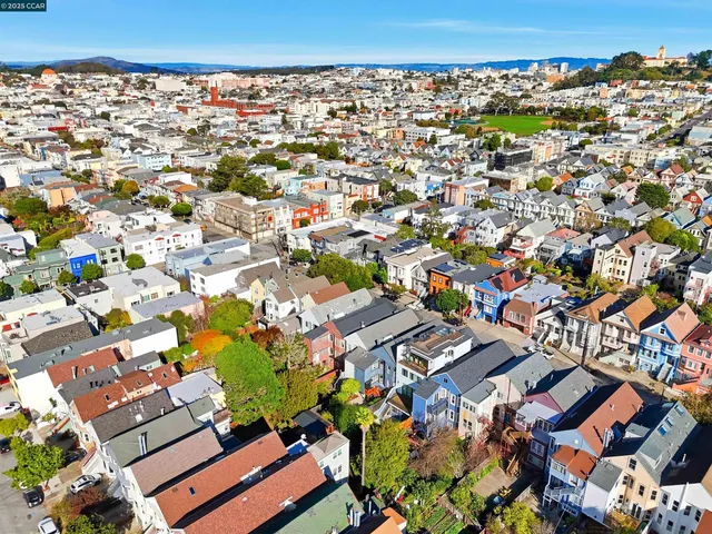 an aerial view of residential houses with outdoor space