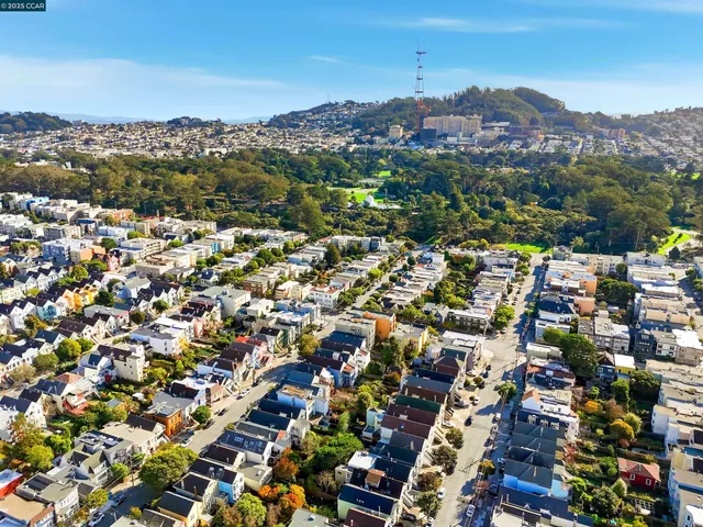 an aerial view of residential houses with outdoor space