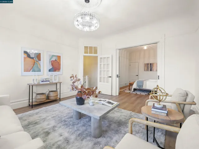 a living room with furniture and a chandelier