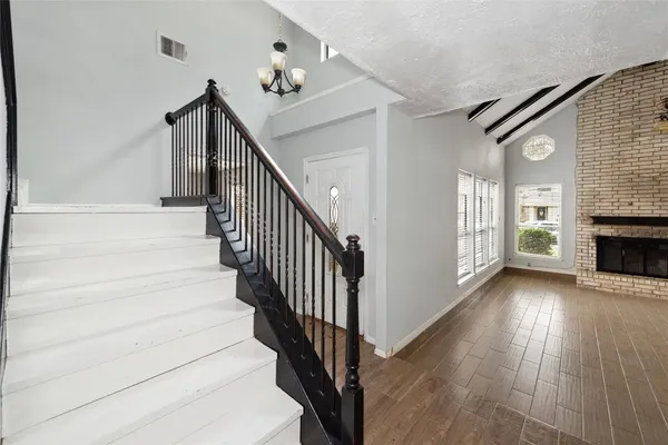 a view of entryway and hall with wooden floor