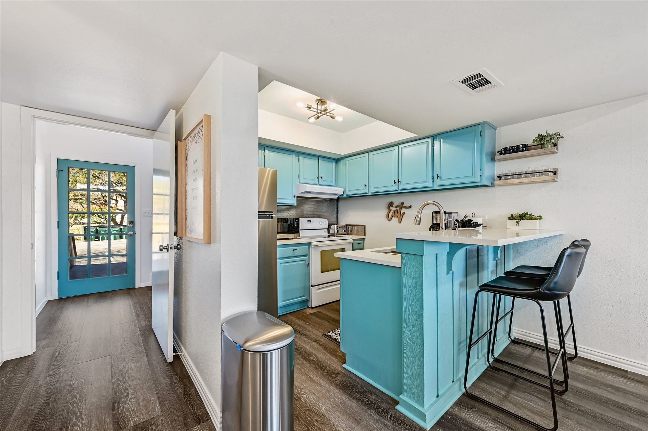 115 Comanche Drive Point Venture, TX 78645 - Photo 6 of 40 a kitchen with cabinets and wooden floors
