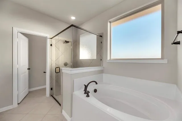 a bathroom with a bathtub and a shower