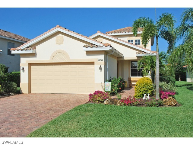 19612 Tesoro Way Fort Myers, FL 33967 - Photo 1 of 14 a front view of a house with a yard and garage