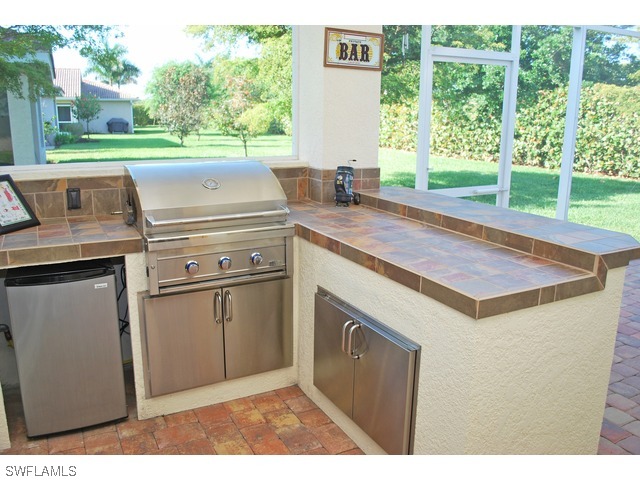 19612 Tesoro Way Fort Myers, FL 33967 - Photo 11 of 14 a kitchen view with a stove and a microwave