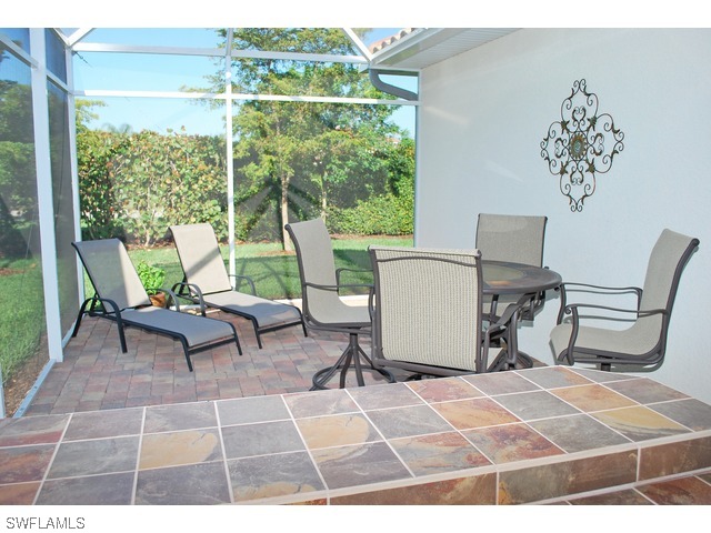 19612 Tesoro Way Fort Myers, FL 33967 - Photo 12 of 14 a room with patio chairs and a table with garden view
