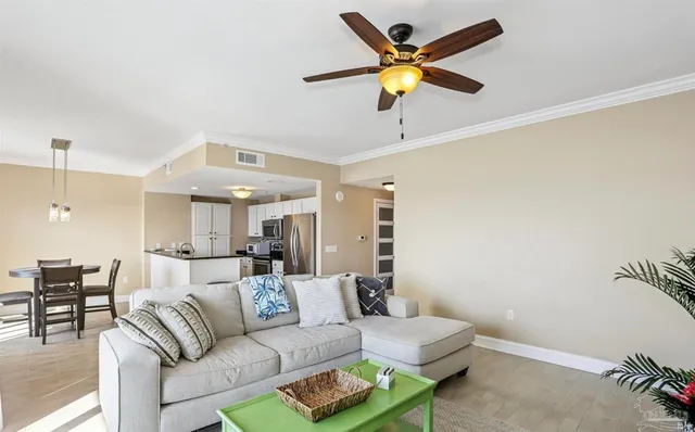 a living room with furniture and kitchen view