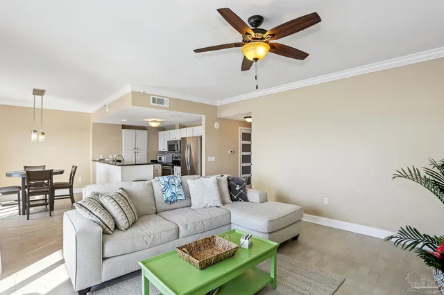 a living room with furniture and a ceiling fan