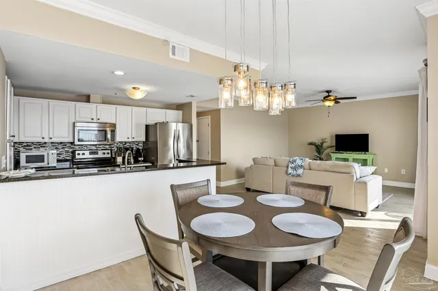 a kitchen with a dining table and chairs