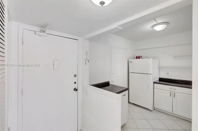 a kitchen with a sink and white cabinets