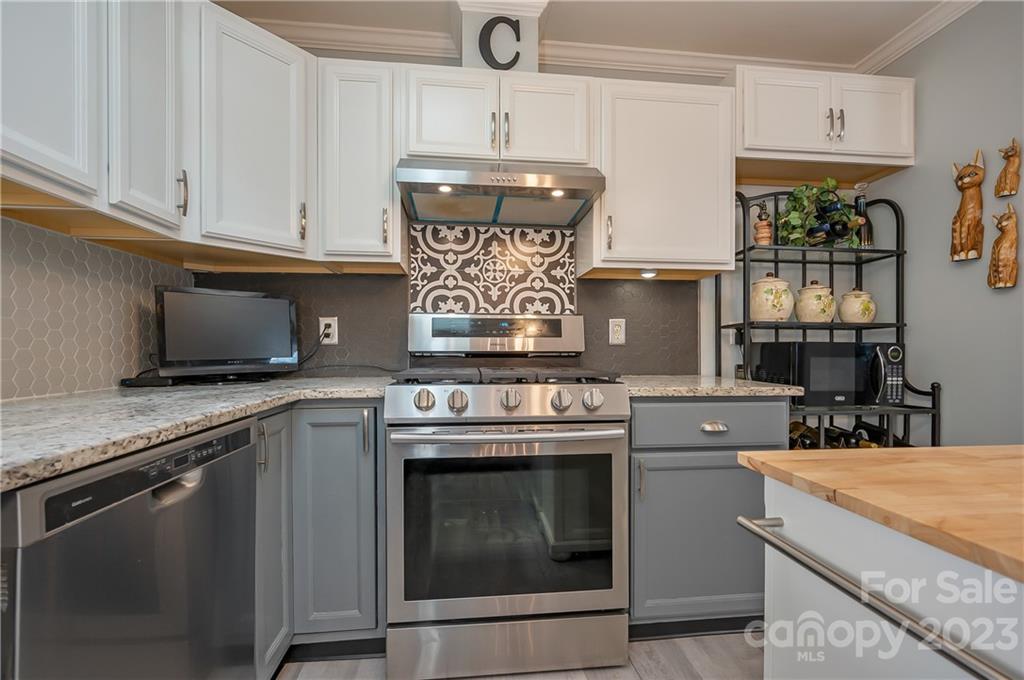481 Plantation Drive Rutherfordton, NC 28139 - Photo 20 of 48 a kitchen with granite countertop a stove sink and cabinets