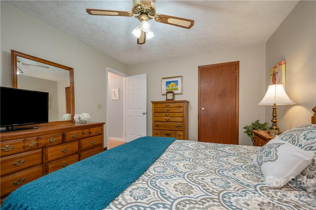 481 Plantation Drive Rutherfordton, NC 28139 - Photo 25 of 48 a bedroom with a bed and a flat screen tv