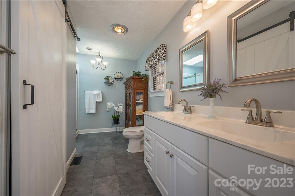481 Plantation Drive Rutherfordton, NC 28139 - Photo 7 of 48 a bathroom with a granite countertop sink mirror and a toilet