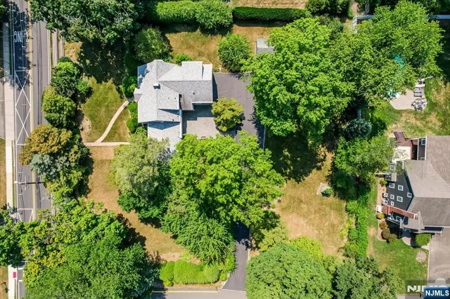an aerial view of a house with a yard and lake view