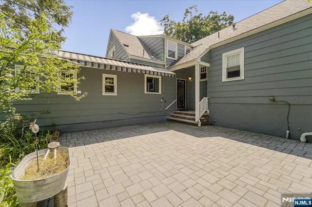 a backyard of a house with a tree