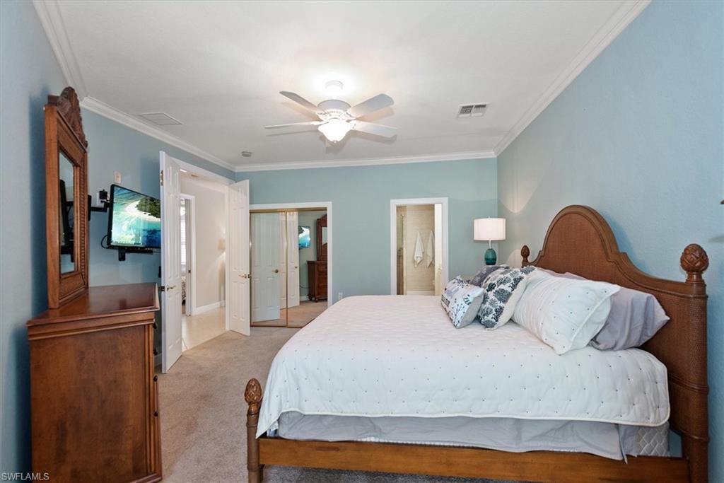 8375 Whisper Trace Way, Unit M203 Naples, FL 34114 - Photo 19 of 36 a bedroom with a bed and wooden floor