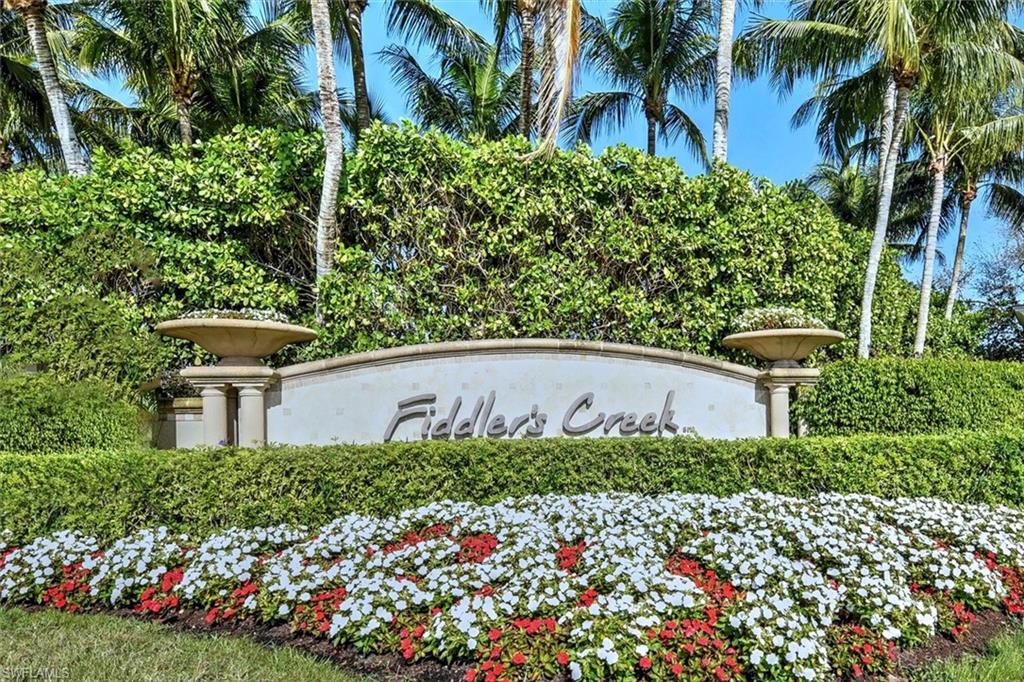 8375 Whisper Trace Way, Unit M203 Naples, FL 34114 - Photo 2 of 36 front view of a house with a yard and potted plants