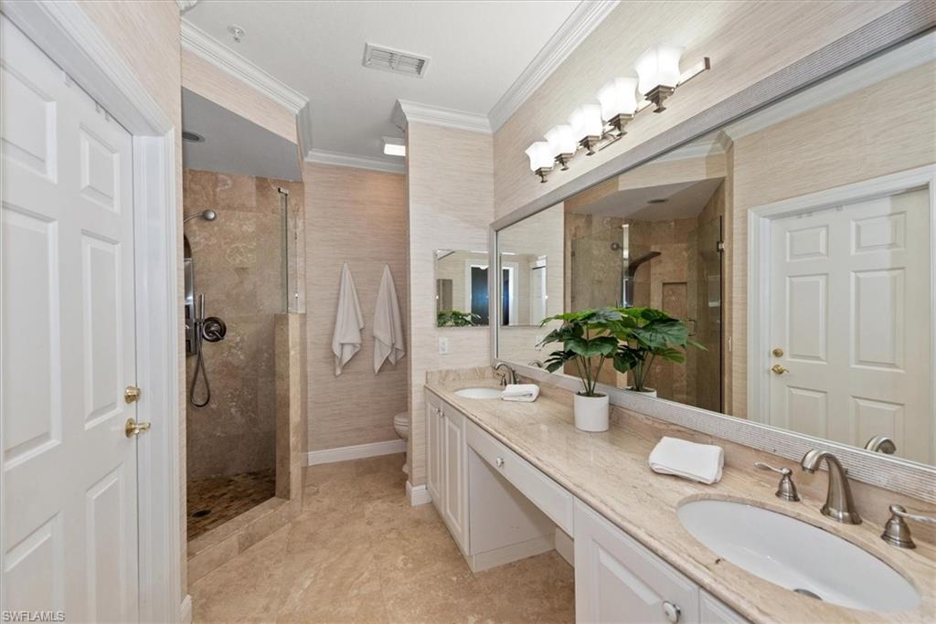 8375 Whisper Trace Way, Unit M203 Naples, FL 34114 - Photo 21 of 36 a bathroom with a granite countertop double vanity sink mirror and shower