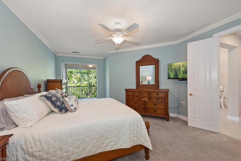 8375 Whisper Trace Way, Unit M203 Naples, FL 34114 - Photo 22 of 36 a bedroom with a bed and a dresser