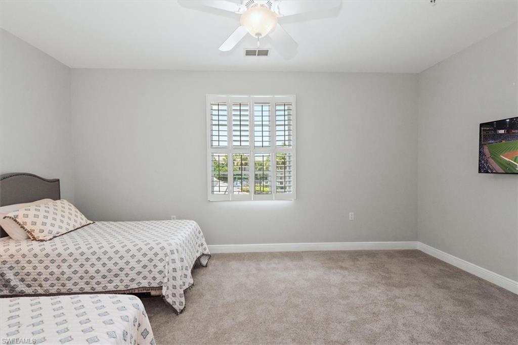 8375 Whisper Trace Way, Unit M203 Naples, FL 34114 - Photo 25 of 36 a bedroom with a bed and a window