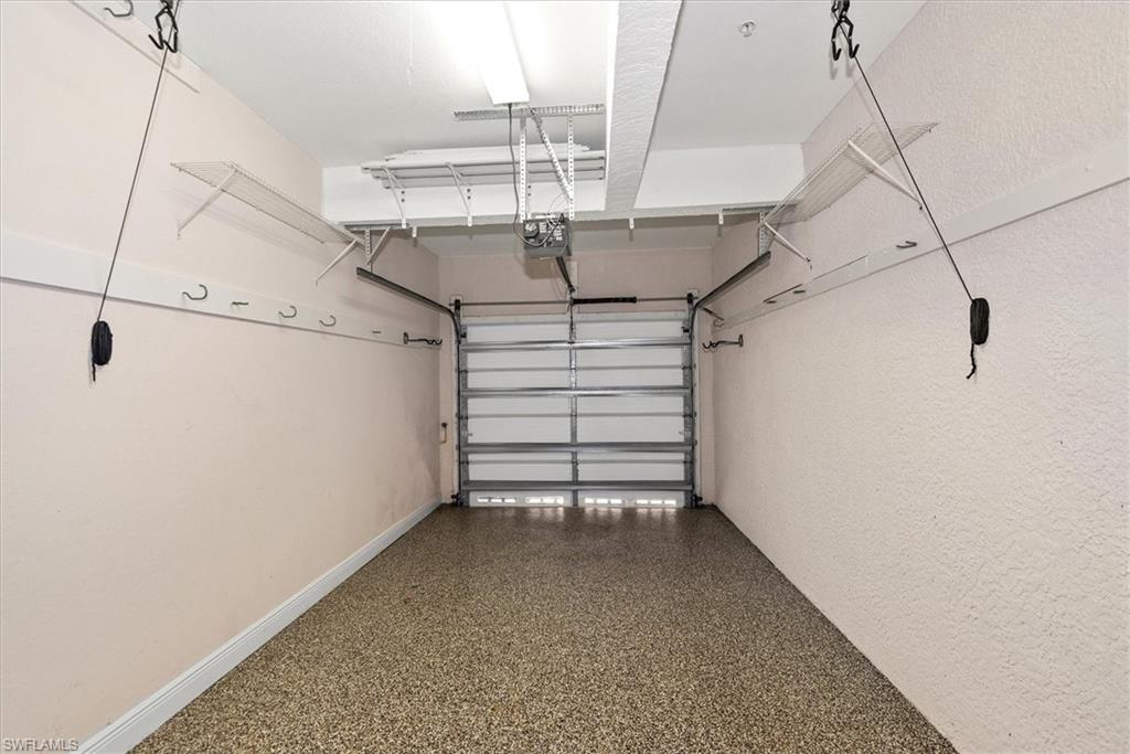 8375 Whisper Trace Way, Unit M203 Naples, FL 34114 - Photo 31 of 36 a view of a room with racks on the wall