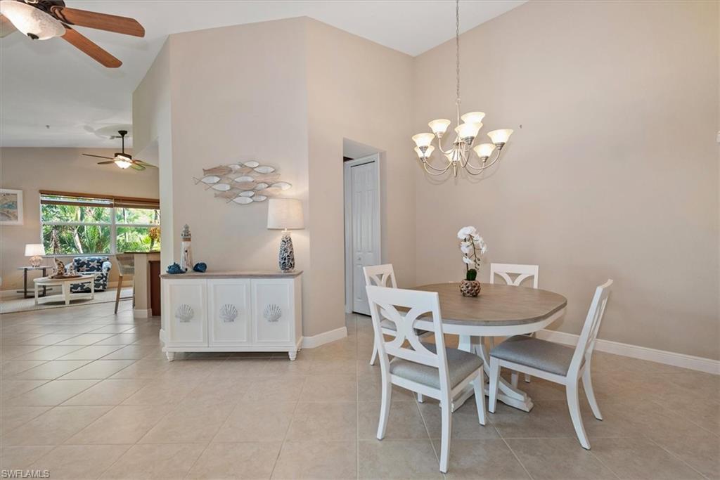 8375 Whisper Trace Way, Unit M203 Naples, FL 34114 - Photo 8 of 36 a dining room with furniture and chandelier