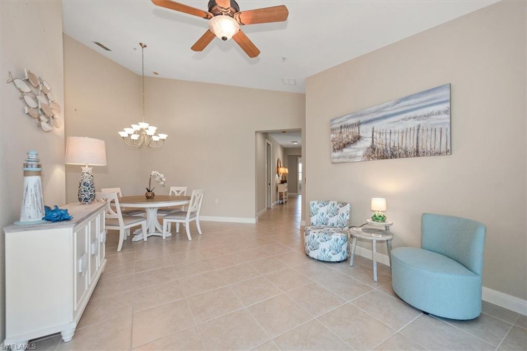 8375 Whisper Trace Way, Unit M203 Naples, FL 34114 - Photo 9 of 36 a living room with furniture and a chandelier
