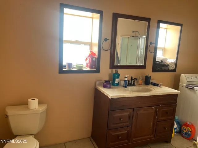 a bathroom with a toilet sink and mirror